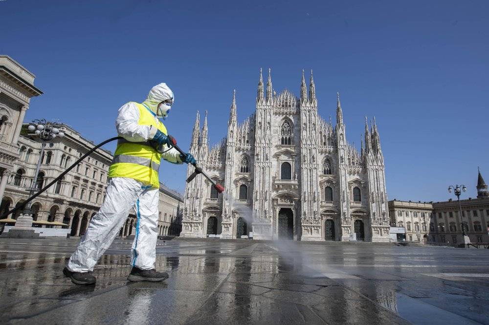 A worker sprays disinfectant to sanitize Duomo square, in Milan, Italy (AP Photo/Luca Bruno)